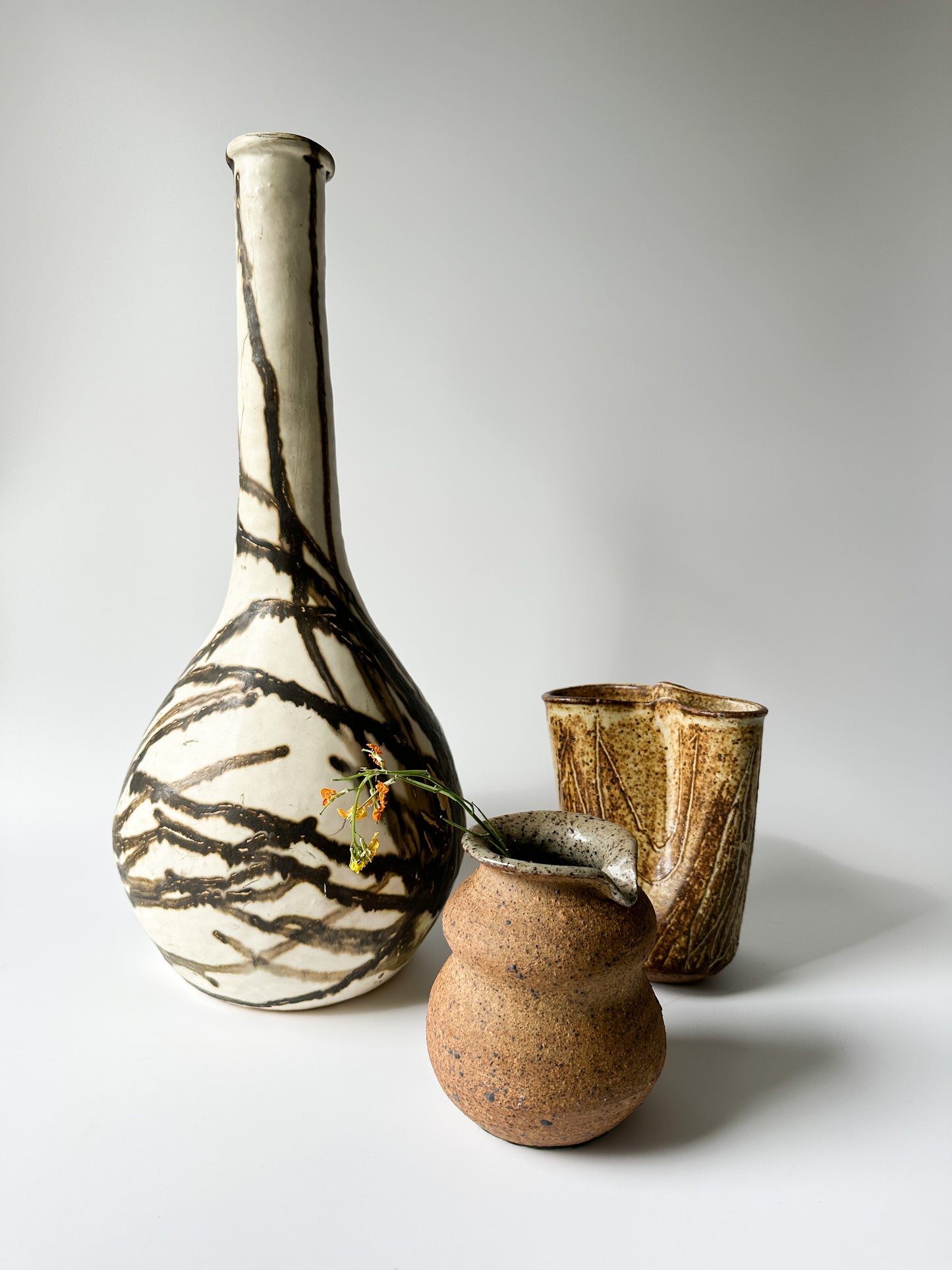 Tall Cream and Black Pottery Vessel