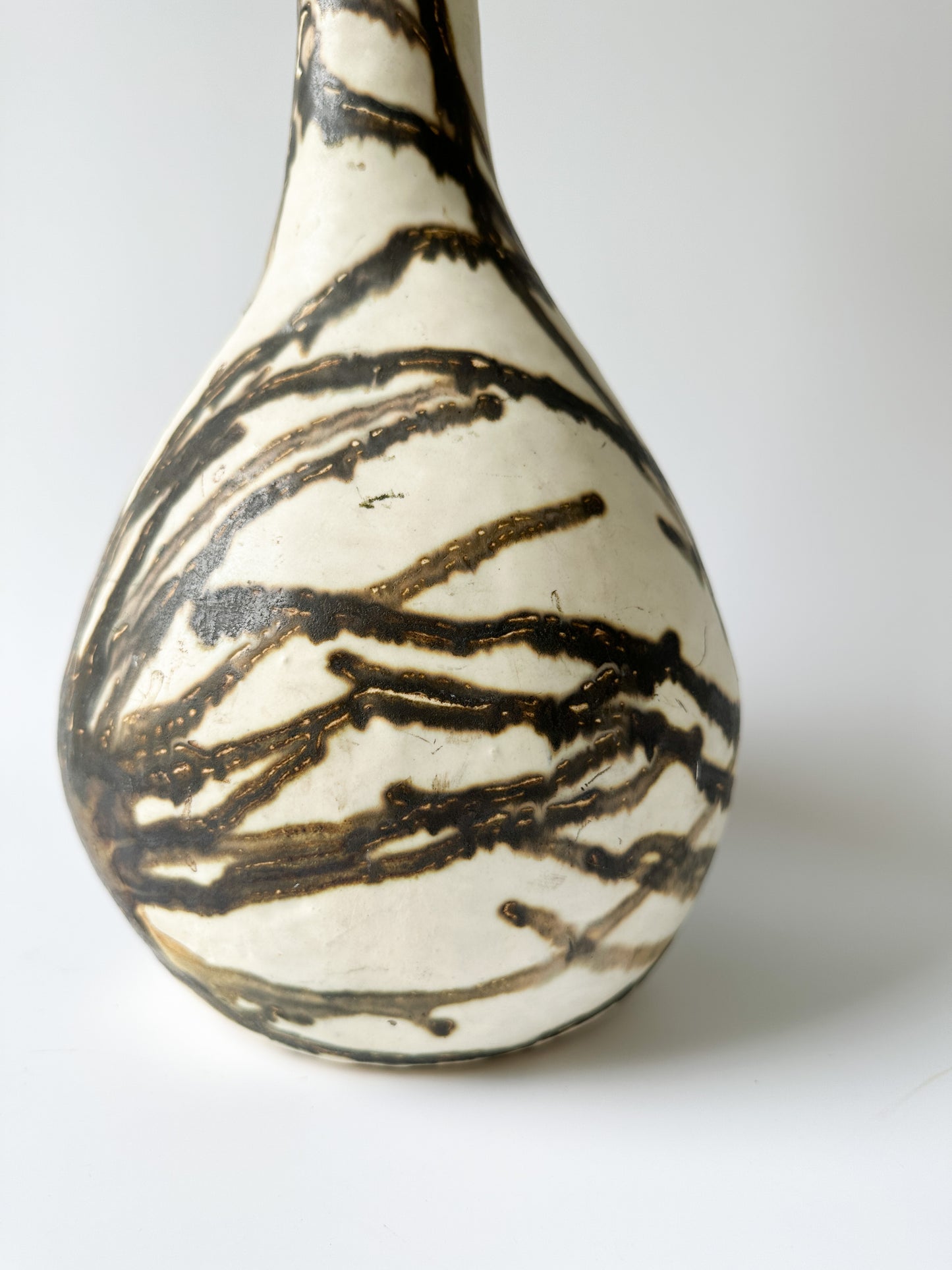 Tall Cream and Black Pottery Vessel