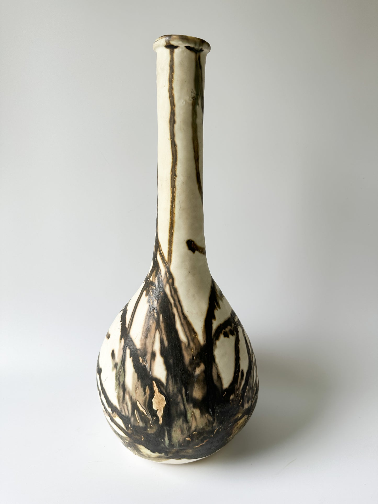 Tall Cream and Black Pottery Vessel