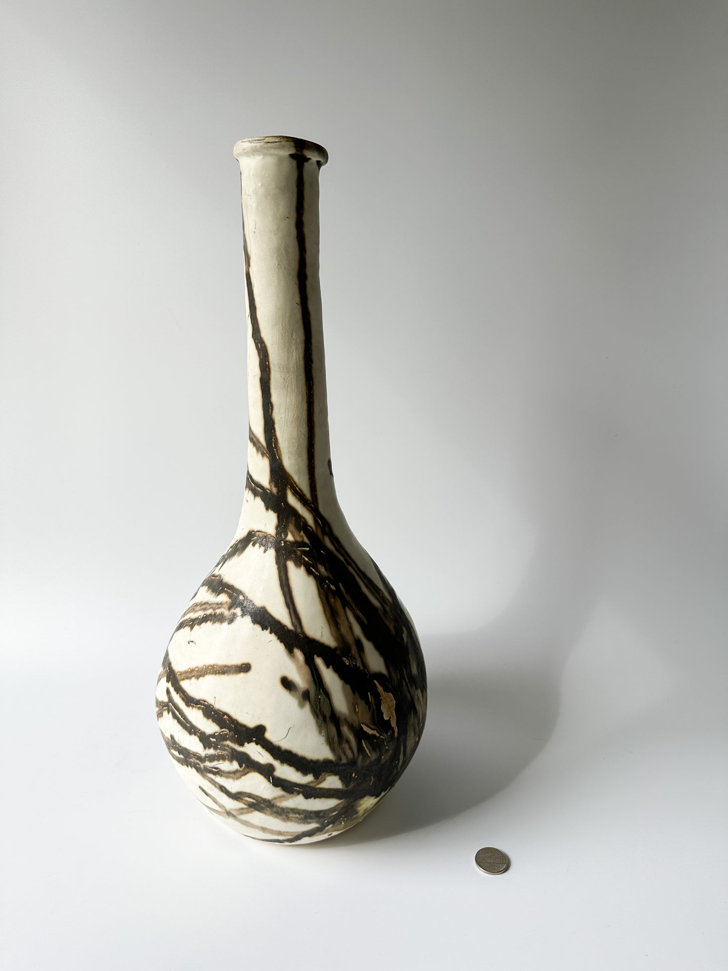 Tall Cream and Black Pottery Vessel